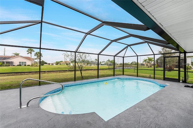 view of pool with a lanai, a patio area, and a yard