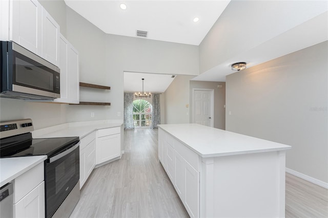 kitchen featuring a center island, an inviting chandelier, white cabinets, light hardwood / wood-style floors, and stainless steel appliances