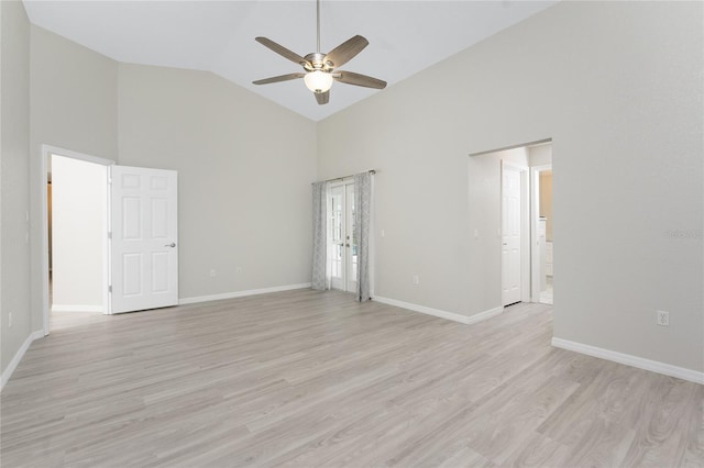 empty room featuring light wood-type flooring, high vaulted ceiling, and ceiling fan