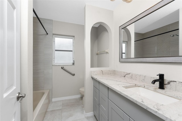 full bathroom featuring tile patterned flooring, vanity, tiled shower / bath combo, and toilet