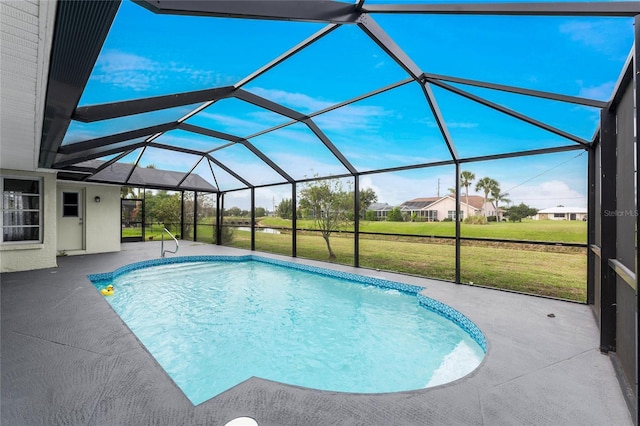 view of pool featuring a patio, glass enclosure, and a lawn