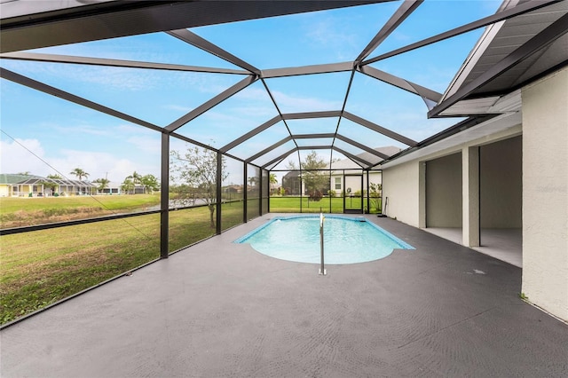 view of pool featuring glass enclosure, a patio area, and a yard