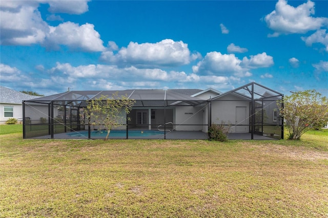 back of house featuring glass enclosure and a yard