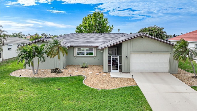 single story home featuring a garage and a front lawn