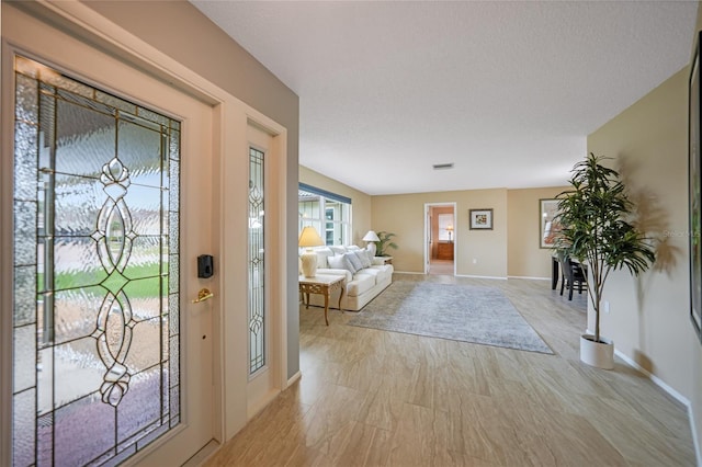 foyer featuring a textured ceiling