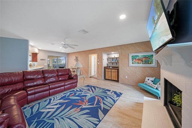 living room featuring wooden walls and ceiling fan