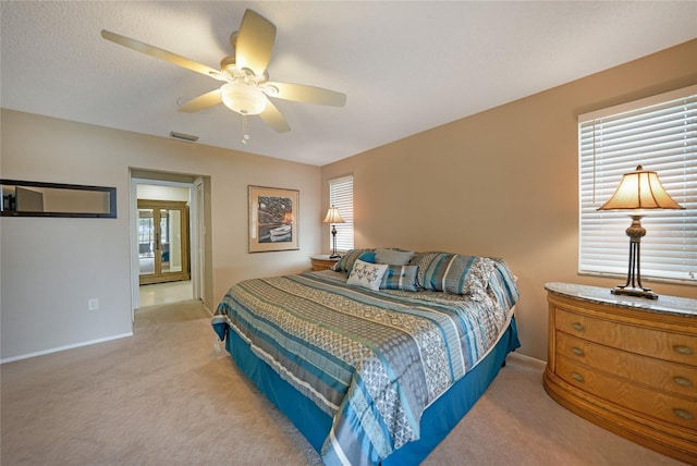 bedroom featuring ceiling fan and light carpet