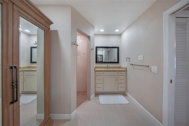 bathroom featuring vanity and a tile shower