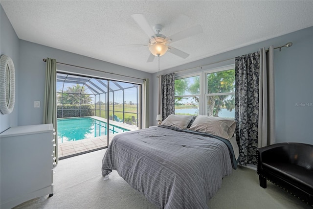 carpeted bedroom with ceiling fan, a textured ceiling, and access to outside