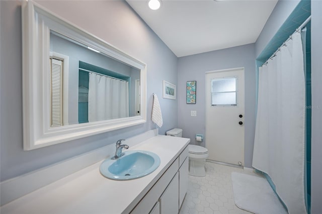 bathroom with tile patterned flooring, vanity, and toilet