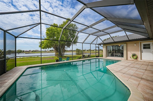 view of swimming pool with a lanai, a patio area, and a water view