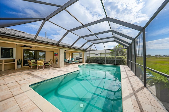 view of swimming pool with outdoor lounge area, ceiling fan, a patio area, and glass enclosure