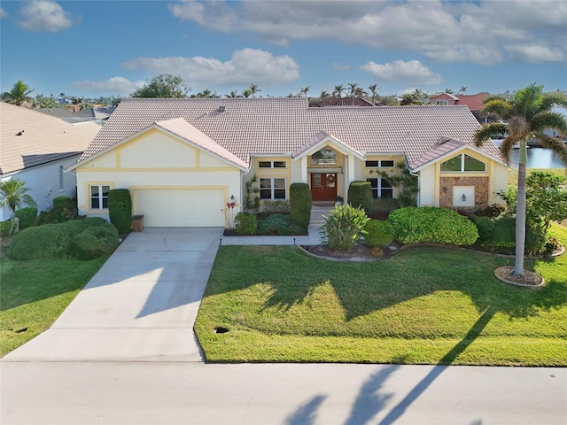 ranch-style home with a garage and a front lawn