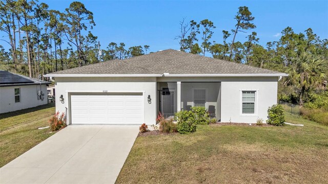 ranch-style house featuring a front lawn and a garage