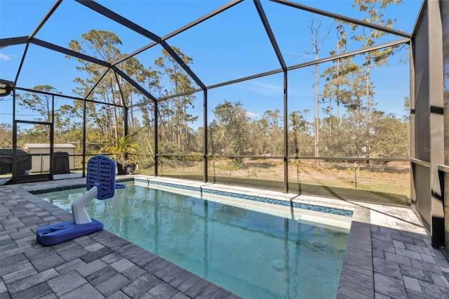 view of swimming pool featuring a patio and a lanai