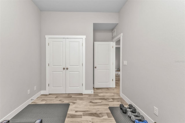 unfurnished bedroom with a closet and light hardwood / wood-style floors