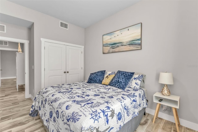 bedroom featuring light hardwood / wood-style flooring and a closet