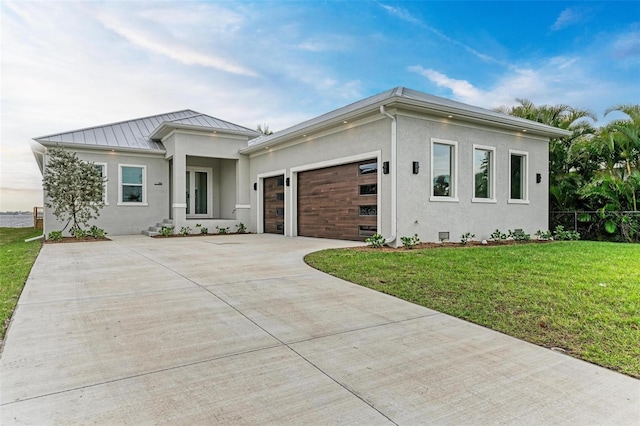 view of front of home featuring a garage and a front lawn