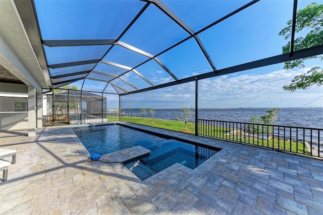 view of swimming pool featuring an in ground hot tub, a water view, glass enclosure, and a patio area