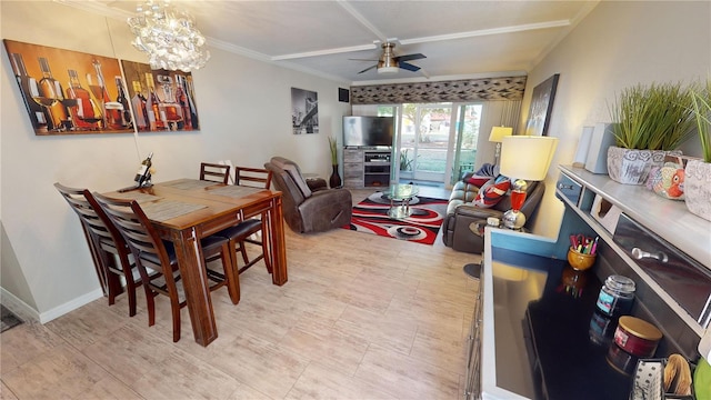 dining area featuring ceiling fan with notable chandelier and ornamental molding