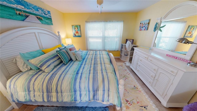 bedroom with multiple windows and ceiling fan