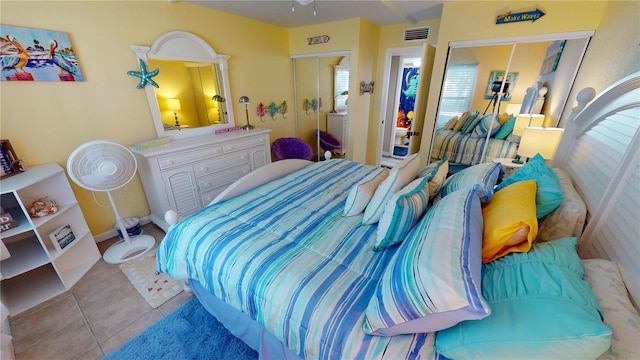 tiled bedroom with a closet