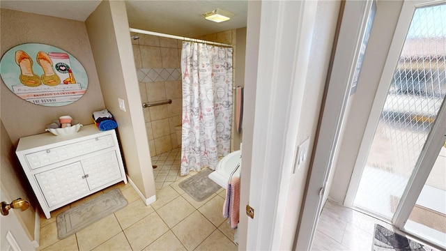 bathroom featuring tile patterned flooring and a shower with curtain