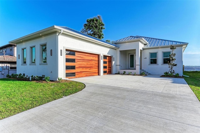 contemporary house featuring a garage and a front lawn