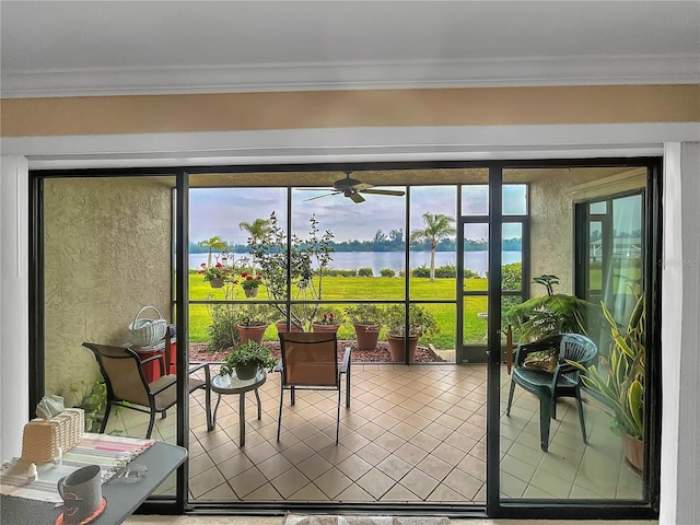 sunroom / solarium featuring a water view and ceiling fan