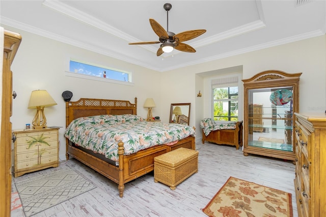 bedroom with ceiling fan, light hardwood / wood-style floors, ornamental molding, and multiple windows