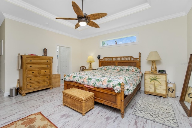 bedroom featuring ornamental molding, ceiling fan, light hardwood / wood-style flooring, and a closet