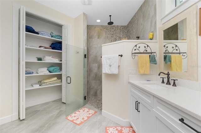 bathroom featuring walk in shower, tile patterned floors, and vanity