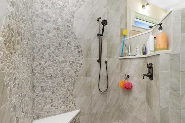 bathroom with tiled shower