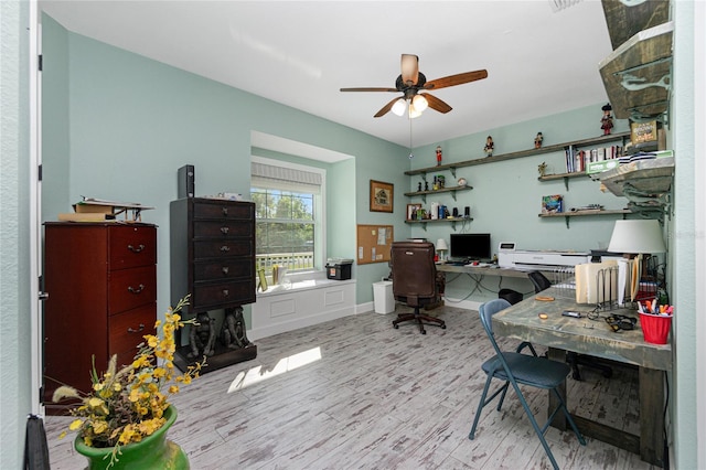 office space with ceiling fan and light hardwood / wood-style flooring