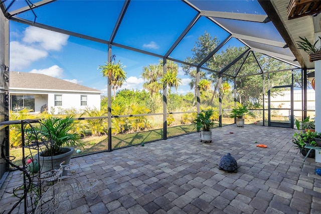 view of patio featuring glass enclosure