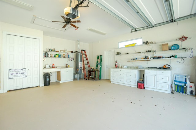 garage featuring gas water heater, ceiling fan, and a garage door opener