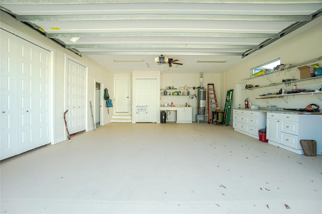 garage with ceiling fan, gas water heater, and a garage door opener