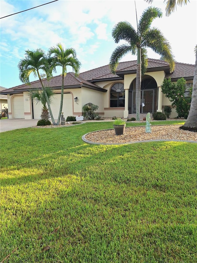 view of front of house featuring a garage and a front lawn