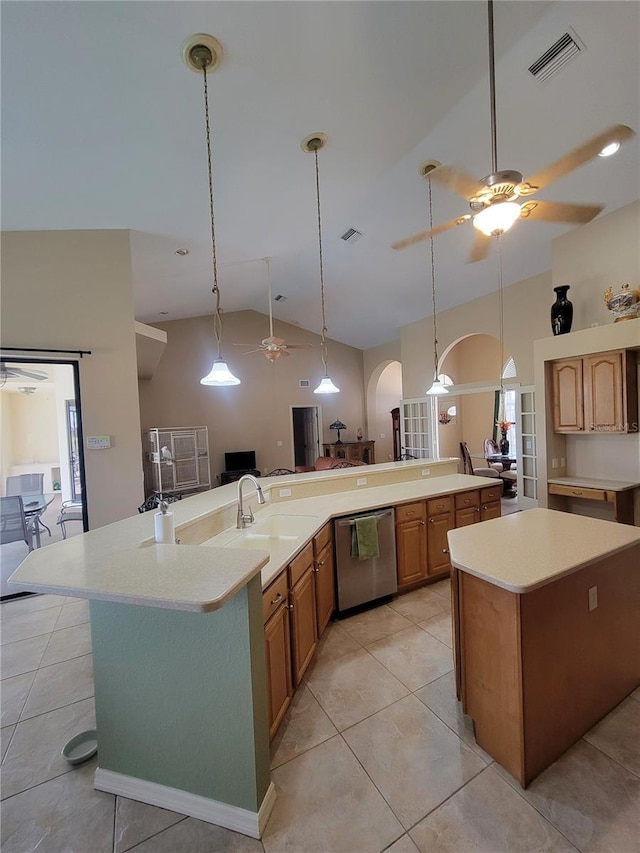 kitchen with stainless steel dishwasher, a large island, light tile patterned floors, and sink