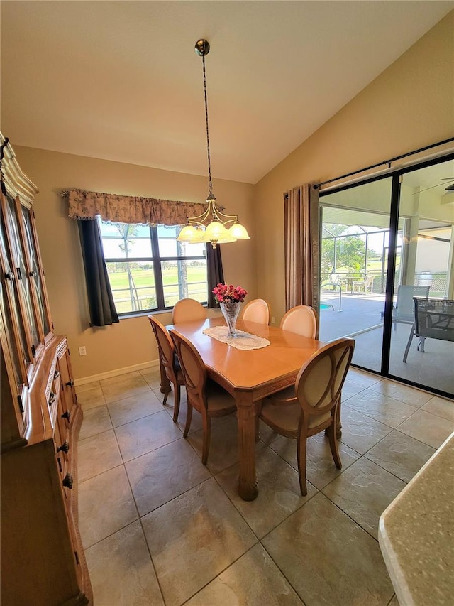 tiled dining space with vaulted ceiling