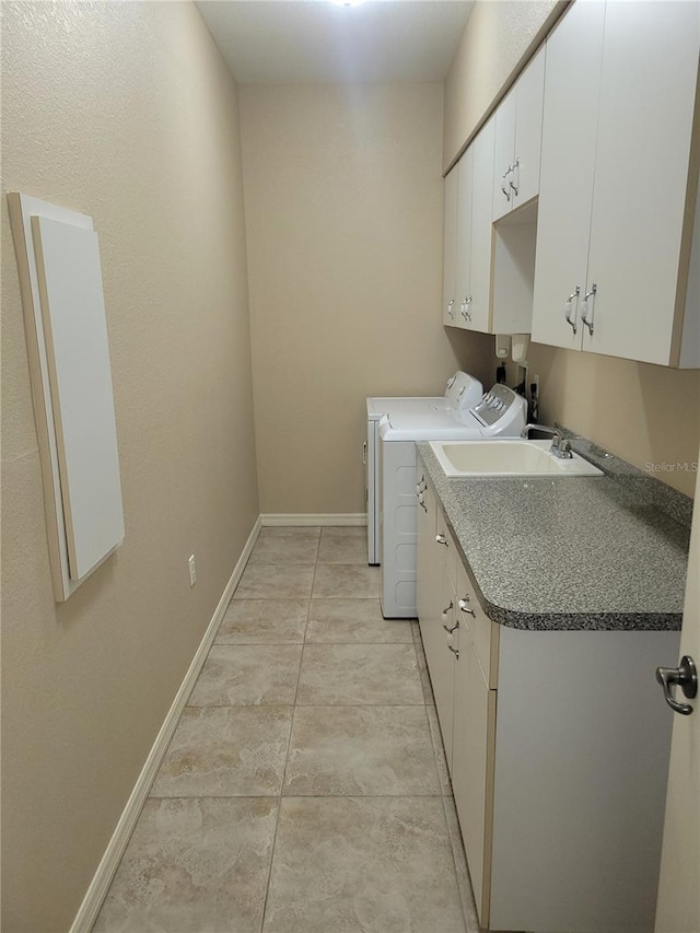 laundry area with light tile patterned flooring, cabinets, sink, and washing machine and dryer