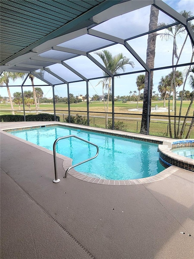 view of pool featuring an in ground hot tub and a lanai