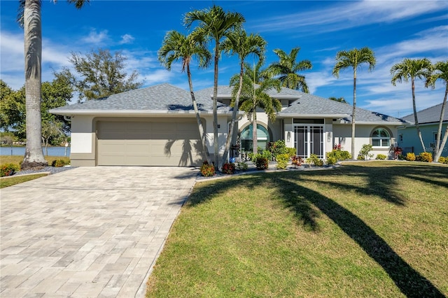 ranch-style home with a front yard and a garage