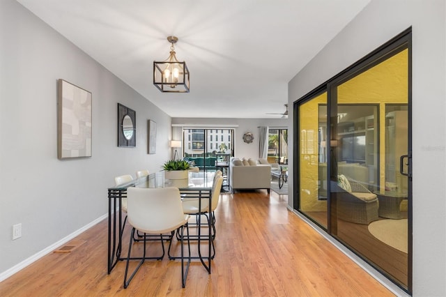 dining room featuring hardwood / wood-style flooring and an inviting chandelier