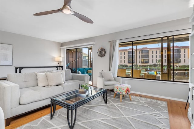 living room with hardwood / wood-style flooring and ceiling fan