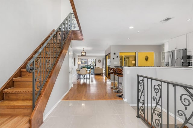 staircase with tile patterned floors