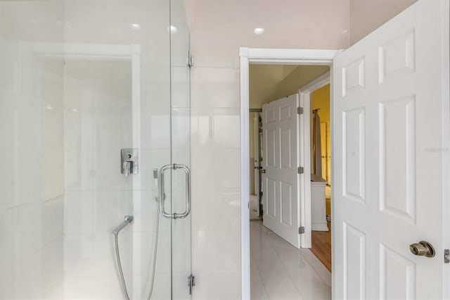 bathroom featuring tile patterned flooring and a shower with door