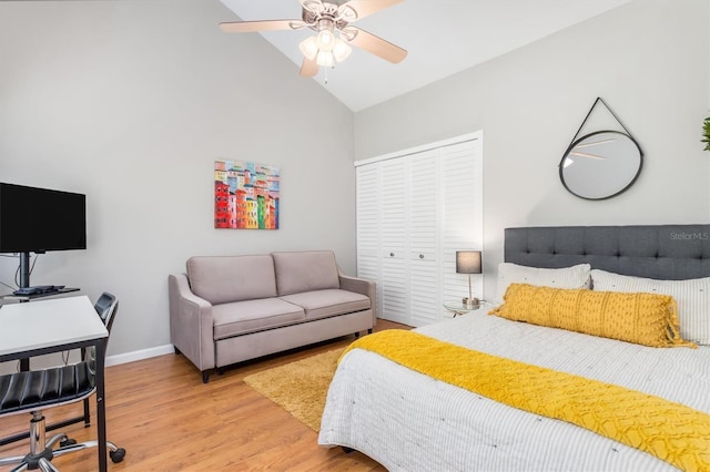 bedroom featuring ceiling fan, a closet, vaulted ceiling, and light wood-type flooring