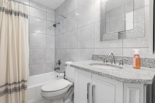 full bathroom featuring shower / bath combination with curtain, vanity, toilet, and tile walls