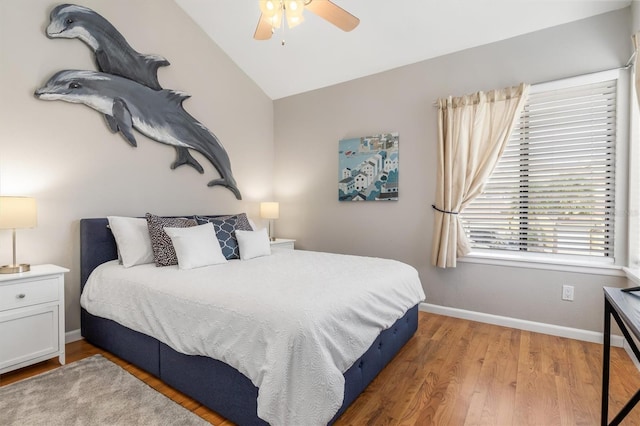 bedroom featuring ceiling fan, lofted ceiling, and hardwood / wood-style flooring